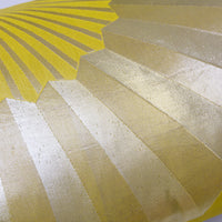 Detail of chartreuse kimono silk pillow with gold fans.
