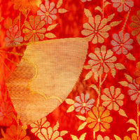 Red silk upcycled kimono pillow with woven gold fan and flower designs.