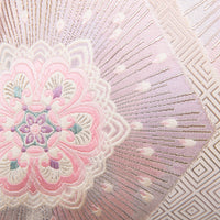 Detail of pink silk obi pillow with silver, cream and pale blue accents.