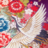 Detail of crane embroidery on uchikake purple pillow by Hunted and Stuffed, London.